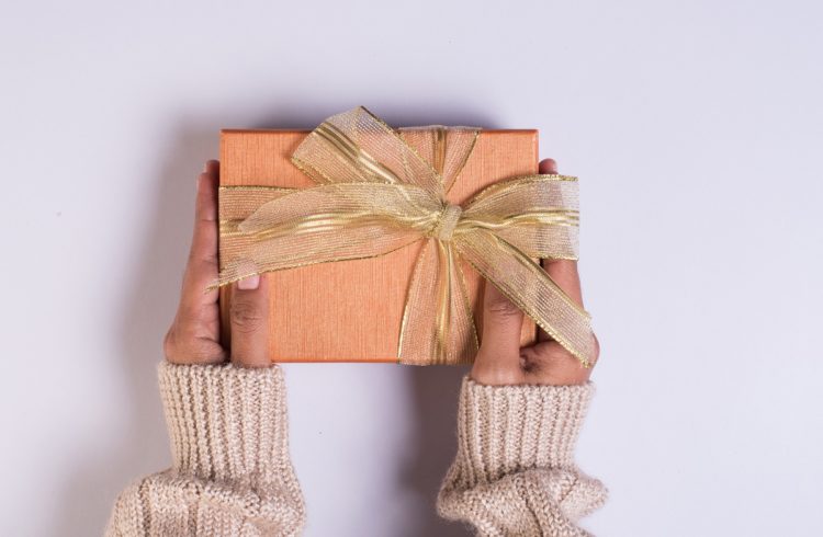 Top view Hand holding gift box on work space